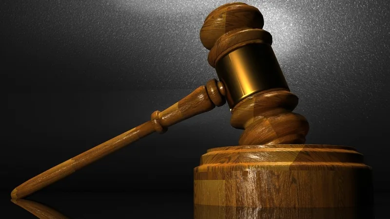 A wooden judge's gavel on a dark background