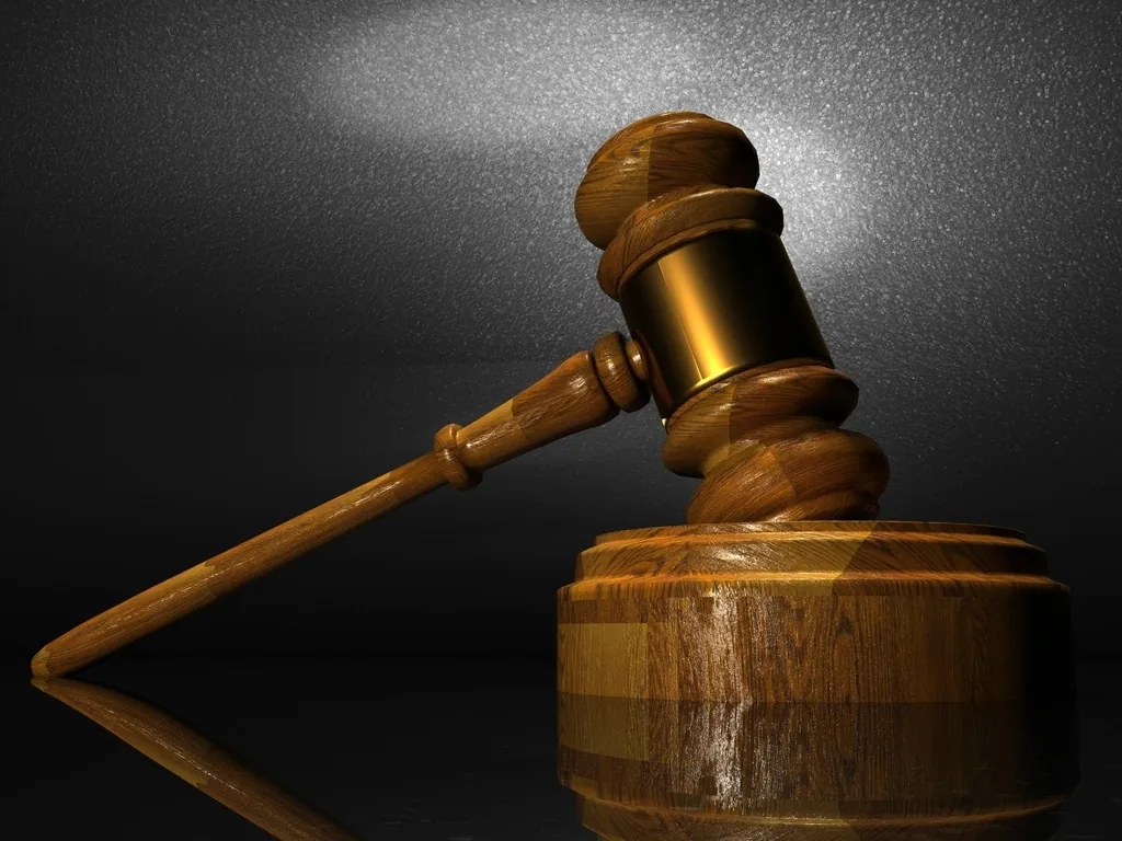 A wooden judge's gavel on a dark background