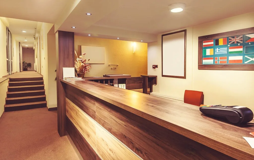 An empty reception desk in a hotel lobby